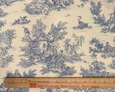 a ruler is shown next to a blue and white wallpaper with birds, trees, and other animals