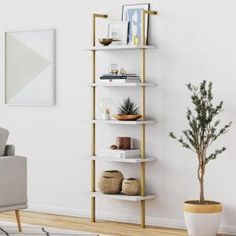 a living room with a couch, chair and shelving unit in the corner next to a potted plant