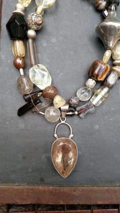 Walk that walk like the  fashionista you are..a fun neutral piece to compliment any outfit.  A large quartz pendant is surrounded by various sizes and shapes of quartz beads. Agate, jasper and crazy horse are also added.  Be individual..make a statement! Measures 18 inches. Hook closure. #yourjewelryshouldmakeyousmile Item # 370 Gem Stone Necklace, Large Bead Necklace, Art Statement, Art Necklace, Diy Jewelry Necklace, Art Necklaces, Bracelet Display, Chunky Jewelry, Jewelry Boho