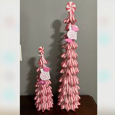 two pink and white candy cane christmas trees