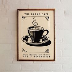 a coffee cup on a saucer with the words the grand cafe art et decoration