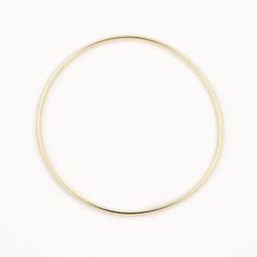 14k gold plated Sterling Silver 63cm inner diameter  1.8mm width  Our gold bangles are a classic and dainty piece of jewellery that is a staple to everyone's jewellery collection. Whether you wear it as a stand alone statement piece or later it with 2 or 3 bangles and even add some bracelets. These bangles make the perfect gift for yourself or someone special and comes packaged in a beautiful box. Minimalist Brass Gold Bracelet Tarnish Resistant, Minimalist Yellow Gold Bangle Jewelry, Minimalist Yellow Gold Hoop Bracelet, Minimalist Brass Bangle, Minimalist Yellow Gold Brass Bangle, Minimalist Gold Hoop Bracelet, Delicate Gold Bangle Bracelet, Minimalist 14k Gold Bangle Jewelry, 14k Gold Filled Bangle In Gold Color