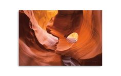 the interior of a slot in antelope canyon with water running through it and light shining on the floor