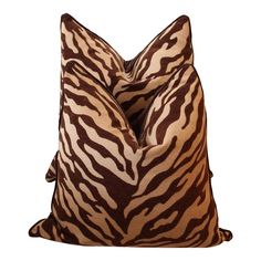 a brown and white zebra print pillow on a white background