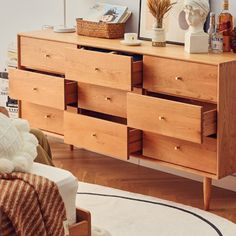 a wooden dresser sitting on top of a hard wood floor next to a white rug