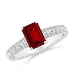 a red stone ring with diamonds on it