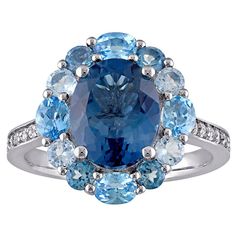 Add a colorful finishing touch to any ensemble with this elegant sterling silver Stella Grace blue topaz halo ring. Click on this JEWELRY & WATCHES GUIDE to learn about fit, styles, materials and more! Add a colorful finishing touch to any ensemble with this elegant sterling silver Stella Grace blue topaz halo ring. Click on this JEWELRY & WATCHES GUIDE to learn about fit, styles, materials and more! FEATURES Band width: 16.7 mm Shank style: halo Band fit: comfort fit Nickel free Metal: sterling silver Plating: rhodium Finish: polished Packaging: boxedSTONE DETAILS Stone type: Swiss blue topaz, London blue topaz, sky blue topaz Total weight: 5 3/8 ct. Center stone weight: 3 5/8 ct. Center stone size: 10 mm x 8 mm Shape: oval, round Setting: prong, shared prong Gemstones may have been treat Luxury Blue Topaz Halo Ring, Elegant Blue Gemstones With Halo Setting, Blue Oval Multi-stone Cluster Ring, Elegant Sapphire Multi-stone Topaz Ring, Oval Blue Gemstones With Halo Setting, Elegant Multi-stone Topaz Ring, White Gold Multi-stone Topaz Ring, Dazzling Blue Multi-stone Rings, Dazzling Blue Topaz Ring With Halo Setting