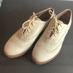 Cream Leather Uppers Deep Tan/Burnt Orange Sole Cream Laces Never Worn Box Not Included Excellent Condition! Elegant Beige Lace-up Flats, Classic Flat Lace-up Shoes For Office, Business Casual Flat Oxfords With Brogue Detailing, Elegant Beige Lace-up Shoes For Spring, Classic Beige Closed Toe Oxfords, Spring Oxfords With Perforated Toe Box, Classic Flat Oxfords With Brogue Detailing, Flat Oxfords With Brogue Detailing For Office, Classic Wingtip Flats With Brogue Detailing