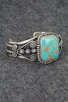 This beautiful and substantial Royston turquoise and sterling silver bracelet was made by Navajo silversmith Michael Calladitto. The back is signed M&R Calladitto, Navajo and stamped .925.Size: 5 1/2" (will fit up to a 6 7/8" wrist)Gap: 1 3/8"Width: 1 1/2"Free shipping on all orders! We ship with USPS and always include tracking. All orders ship within a day of payment.Returns are accepted up to 30 days after you receive your order. Just send us a message. Our shop offers cash back or store cred Engraved Turquoise Sterling Silver Bracelet Gift, Sterling Silver Turquoise Concho Jewelry, Western Sterling Silver Cuff Bracelet Gift, Artisan Turquoise Engraved Bracelets, Stamped Turquoise Bracelet, Engraved Turquoise Jewelry Bracelet, Artisan Turquoise Engraved Bracelet, Engraved Turquoise Bracelet Jewelry, Elegant Sterling Silver Bracelet With Turquoise