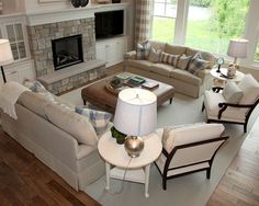 a living room filled with furniture and a fire place in the middle of a room