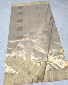 1.this is beautiful pure chanderi pure tissue golden zari weaving all over with meenakari butta weavinv with running blouse piece . 2.this sari is 5.5 mt length  3.this is a very elegant looking sari for all occasions like weddings and other formal events  4.fall n pico is complimentary  5.blouse can be made as per the requirements of the clients with proper measurements.stiching charges will be extra  6.plz check the availability of the sari before placing the order Gold Tussar Silk Traditional Wear With Cutdana, Gold Chanderi Traditional Wear For Festivals, Elegant Tissue Silk Dupatta With Meenakari, Gold Tussar Silk Traditional Designer Wear, Designer Gold Tussar Silk Traditional Wear, Gold Tussar Silk Traditional Wear For Designer Occasions, Designer Paithani Silk Traditional Wear In Gold, Gold Chanderi Traditional Wear With Cutdana, Chanderi Dupatta With Pallu