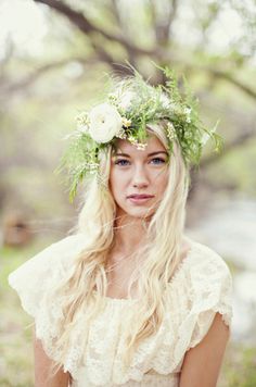 a woman with long blonde hair wearing a flower crown