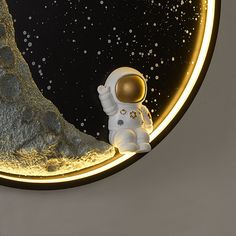 an astronaut is looking at the moon through a circular window with a yellow light on it