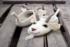 a pair of slippers made to look like a deer's head