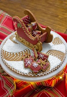 a plate with some cookies on it sitting on a red and white cloth covered tablecloth