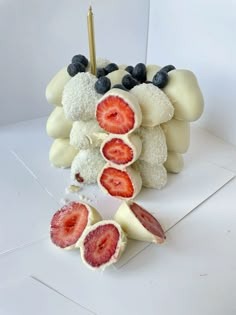 strawberries and blueberries are arranged on top of marshmallows in the shape of sheep's heads