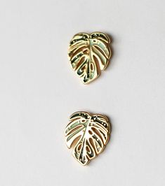 Inspired by the rare and beautiful Thai Constellation Monstera Deliciosa, these plant earring studs are the perfect gift for the nature and plant enthusiast. Our earrings are plated in 18K gold and made of high quality materials, hypoallergenic and nickel-free. Our botanical leaf earring designs were inspired by the rare plant, Thai Constellation Monstera. These earrings make the perfect gift for the plant lover or nature enthusiast. You can bring your love of plants with you, wherever life may lead.  ABOUT HAPPILY PLANTS We are a daughter and mom run botanic design company. Our pieces are designed, illustrated and assembled by us in New Jersey. THE PERFECT GIFT These botanical earring studs make the perfect gift for the trendy plant enthusiast in your life for Mother's Day, Birthdays and Thai Constellation Monstera, White Monstera, 3 Dimensional Shapes, Plant Necklace, Thai Constellation, Monstera Albo, Trendy Plants, Nature Enthusiast, Leaf Earring