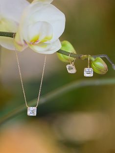 Available in asscher cut clear topaz or green amethyst Stone size is 8 mm in diameter Fastens with a French clip 14k Gold