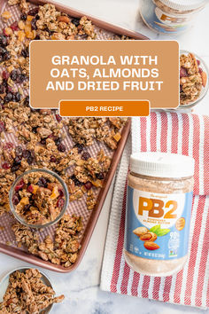 granola with oats, almonds and dried fruit on a baking sheet next to a jar of peanut butter