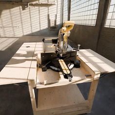 a table that is made out of wood and some tools on top of the table