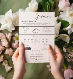 a person holding up a wedding program with flowers in the background