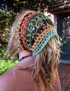 the back of a woman's head wearing a multicolored crocheted hat