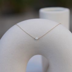 The Sam Necklace is the perfect dainty necklace for sophistication and fun. It's intentionally petite so you never have to take it off, while also being the perfect staple necklace you can layer with chains, crosses, or other diamond styles. It features a .25 carat oval diamond, measuring about 5mm x 3.5mm. It sits in a custom-designed invisible setting, and is fixed horizontally on a dainty 16-18" adjustable chain. Use code "SAMCIACCIA" at checkout for free shipping, and for an automatic contri Everyday Diamond Birthstone Necklace, Minimalist Solitaire Necklace With Diamond Cut For Everyday Luxury, Minimalist Single Diamond Jewelry For Everyday Luxury, Everyday Fine Jewelry Solitaire Necklace With Single Diamond, Minimalist 14k Gold Diamond Necklace For Everyday Luxury, Everyday Fine Jewelry Solitaire Necklace In Diamond White, Minimalist Solitaire Diamond Necklace For Everyday Luxury, Everyday Solitaire Necklace With Single Diamond, Everyday 14k Gold Timeless Solitaire Necklace