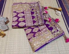 A Lovely Purple Pink Banarasi Georgette Bandhani Gota Patti Saree in Gharchola Pattern. The saree is adorned with intricate gota patti handwork which makes it all the more a perfect choice for occasion wear. Its a fusion of karigari from Banaras, Gujarat and Rajasthan. We must say, a truely heirloom piece. The zari work on the saree is done in Banaras and then the Bandhej is tye and dyed in Gujarat. Then the karigars of Rajasthan have worked their magic with the gota embroidery. So its takes about a couple of months for a single saree to be ready Additional Information Color : Purple Pink Shaded Technique: Bandhani is a tye & dye technique in which fabric is pinched with nails and tied with thread and then dyed to create fabulous patterns. Fabric: Pure Georgette Blouse Piece: Included (Ref Purple Traditional Wear With Dori Work, Traditional Purple Wear With Dori Work, Purple Gota Work Dupatta For Diwali, Traditional Katan Silk Wear With Dori Work For Festivals, Purple Dupatta With Gota Work For Diwali, Festival Katan Silk Traditional Wear With Dori Work, Festive Purple Traditional Wear With Gota Work, Festival Traditional Katan Silk Attire With Dori Work, Purple Traditional Drape With Gota Work