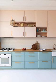 a kitchen with blue cabinets and white appliances