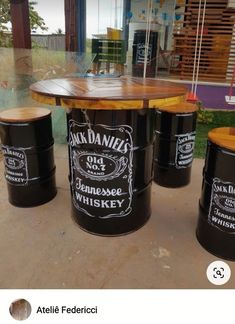 three barrel tables with chalk writing on them