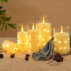 lit candles are sitting on a table next to other items