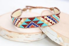 Introducing our adjustable southwestern beaded cuff bracelets! This colorful cuff bracelet is handmade with a southwestern-inspired pattern in cream, dark red, blue, orange, turquoise, and soft yellow.The bracelet is strung on strong beading thread and flexible leather cord with an adjustable closure, making it easy to put on and take off, while also allowing you to customize your fit. It will fit 6-8 inch wrists.Whether you're dressing up for a special occasion or just accenting your everyday s Beading Thread, Orange Turquoise, Beaded Cuff Bracelet, Bead Weaving Patterns, Loom Bracelets, Bead Loom, Beaded Cuff, Soft Yellow, Weaving Patterns