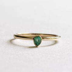 14k yellow gold natural petite emerald teardrop ring Metal: 14k yellow gold Stone: natural emerald Stone Size: 4mmx3mm Stone cut: Pear Stone Carat Weight: 0.17carat Dimension: Approx 1.5mm band. Emerald Teardrop Ring, Gold Teardrop Emerald Ring, Gold Teardrop Emerald Promise Ring, Yellow Gold Teardrop May Birthstone Ring, Yellow Gold Teardrop Ring For May Birthstone, Green Teardrop 14k Gold Ring, Teardrop Emerald Ring In Yellow Gold, Pear-shaped Gold Emerald Ring, Fine Jewelry Emerald Teardrop Ring