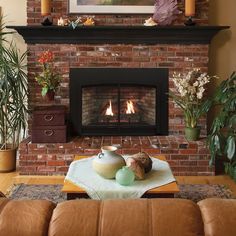 a living room filled with furniture and a fire place in the middle of a fireplace