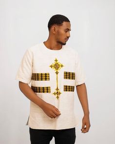 This traditional Ethiopian shirt for men is handmade from high-quality fetil fabric, which is known for its softness and durability. The shirt features a unique tilf detailing, which is a decorative panel that runs along the bottom of the shirt. The tilf is adorned with intricate embroidery and patterns, adding to the beauty and elegance of the shirt. The fetil fabric is breathable and lightweight, making it perfect for warm weather. The shirt is designed with a collarless neckline and a loose, Intricate Embroidery, Welcome To The Party, Decorative Panels, Formal Occasion, Warm Weather, Beautiful Dresses, The Beauty, Nice Dresses, Comfort Fit