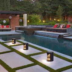 an outdoor living area with grass and lights