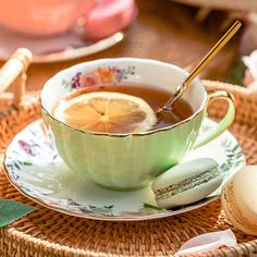 a cup of tea with lemon and macaroons