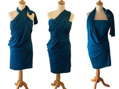 three dresses on mannequins with one draped over the top