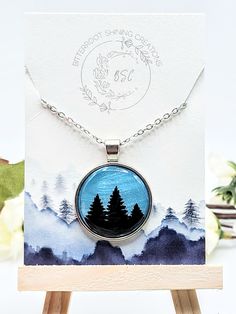 This one of a kind Round Tree pendant was handmade out of polymer clay and and sealed with resin for a durable finish. The chain is high quality stainless steel. If you have questions about this product or if you want to inquire about creating a custom order please don't hesitate to reach out! Artistic Personalized Necklace, Artistic Personalized Round Necklace, Artistic Personalized Round Pendant Necklace, Themed Stainless Steel Jewelry As Gift, Hand Painted Nature-inspired Necklace For Gift, Hand Painted Silver Resin Necklace, Silver Hand-painted Resin Necklace, Silver Polymer Clay Pendant Necklace, Silver Hand Painted Resin Necklace