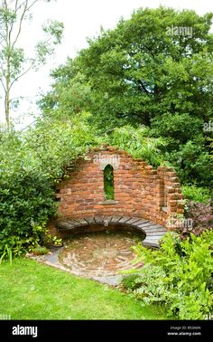 an old brick oven surrounded by greenery and trees