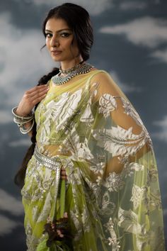 Editor's Note A green patchwork sari in sheer net fabric, it is fully adorned with floral jaal patchwork, aari work and zardozi. The sari comes with a green embroidered blouse handcrafted in chanderi, cotton zari with patchwork and metallic silver. Note: Potli and belt is for styling purposes. Color: Green Fabric: Glass nylon Component: Sari and blouse Occasion: Haldi mehndi and Wedding Guest Care: Dry Clean Only About the Designer Saksham & Neharicka make modernising Indian wear with rich handw