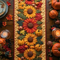 an autumn table runner with sunflowers and pumpkins next to candles on a wooden table