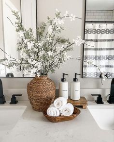 a bathroom with white towels and flowers in a basket