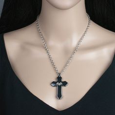 "Add a touch of traditional gothic style to your wardrobe with this cross pendant necklace. It would make a great addition to any dark jewelry collection! 💀 DESCRIPTION: This pendant necklace features a large cross made from hematite that was adorned with a small bat stamping. The cable chain was finished with a lobster clasp. 💀 SIZE & MATERIALS: The stamping was made from oxidized sterling silver plated brass. The chain was made from stainless steel and measures 18\" long. If you would li Black Cross Jewelry For Halloween, Gothic Cross Pendant Jewelry For Halloween, Gothic Cross Jewelry For Gifts, Gothic Cross Jewelry As Gift, Gothic Cross Jewelry Gift, Black Cross Pendant Jewelry For Halloween, Gothic Black Cross Necklace Gift, Gothic Black Crucifix Cross Necklace, Black Cross Pendant Necklace Gift