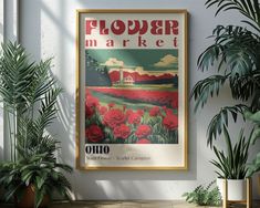 an old poster hangs on the wall next to potted plants and houseplants