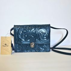 Patricia Nash Laurentina Blue Coral Crossbody Bag. New With Tags. 100% Full-Grain Leather - Burnished Tooled Colors Collection - Adjustable Crossbody Strap - 22" Drop - Flap With Patch Clasp Closure - Signature Brushed Silver Hardware - Faux Suede Lining - Dimensions: 9"(W) X 7"(H) X 3"(D) Elegant Blue Shoulder Bag With Cell Phone Pocket, Luxury Blue Satchel As Gift, Elegant Blue Saddle Bag For Everyday Use, Elegant Blue Satchel With Mobile Phone Bag, Blue Shoulder Bag With Cell Phone Pocket, Blue Shoulder Bag With Cell Phone Pocket For Gift, Blue Satchel Saddle Bag With Removable Pouch, Blue Saddle Bag Satchel With Removable Pouch, Blue Saddle Bag With Removable Pouch