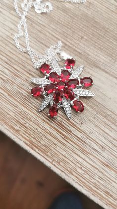 This pendant is gorgeous! It features deep red cz stones,think pomegranate  colored, and clear small cz stones in a snowflake or star pattern. This pendant is bold and beautiful and no one will tell it's not rubies and diamonds! Pendant measures 1 1/2 inches diameter Chain meausres 20 inches Please read the description carefully before purchasing, vintage and retro items as we know have been preowned/preloved. I do my best to describe accurately and honestly the condition of every item with pictures of flaws or issues if there are any. But there will probably be a bit of wear on most items. I always recommend that you hand wash anything vintage as the harsh dishwasher chemicals can erode shine, lustre and patterns. ABOUT SHIPPING I always refund the overage shipping fees for combined shipp Rubies And Diamonds, Snowflake Necklace, Retro Items, Jewelry Holiday, Winter Jewelry, Red Necklace, Pretty Bracelets, Fancy Jewelry, Red Rhinestone