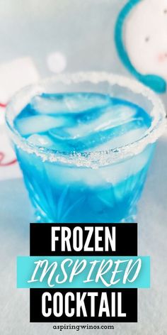 a frozen blue cocktail in a glass with the words frozen inspired cocktail written on it