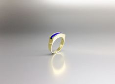 Modern ring blue Lapis Lazuli with solid 18K gold. Unique gift for her, wife, girlfriend, September and December birthstone, 9 year anniversary. Embedded in the 18K gold, the blue Lapis Lazuli gives this ring a modern design. This beautiful ring is worked with the technique of inlay, which means the stone is worked seamlessly into the 18K gold. All our stones are natural stones and our jewelry is handmade, slight differences in color and size may occur. Our inlay work is made with real stone and Modern Yellow Gold Sapphire Ring With Polished Finish, Sapphire 14k Gold Signet Ring Gift, 14k Gold Sapphire Signet Ring As Gift, Modern Blue Sapphire Ring In 14k Gold, Modern Blue Gemstone Signet Ring, Modern Gold Sapphire Ring With Polished Finish, Blue 14k Gold Signet Ring As Gift, Modern Blue Sapphire Ring Hallmarked, Modern Gold Rings With Sapphire