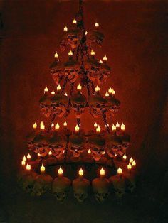 a christmas tree made out of skulls and candles